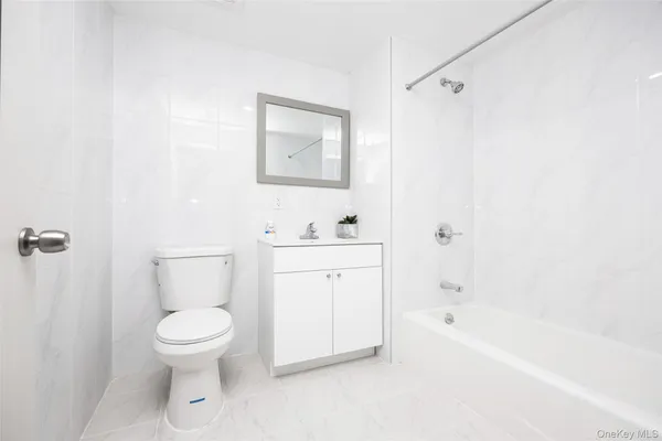 a bathroom with a toilet a sink and bathtub