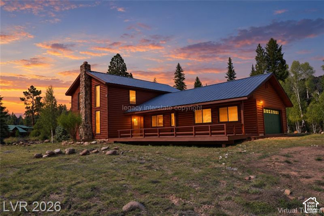 1129 Ponderosa Road, Unit 40 Hatch, UT 84735 - Photo 1 of 47 Log-style exterior featuring a stone chimney, metal roof, and an expansive deck