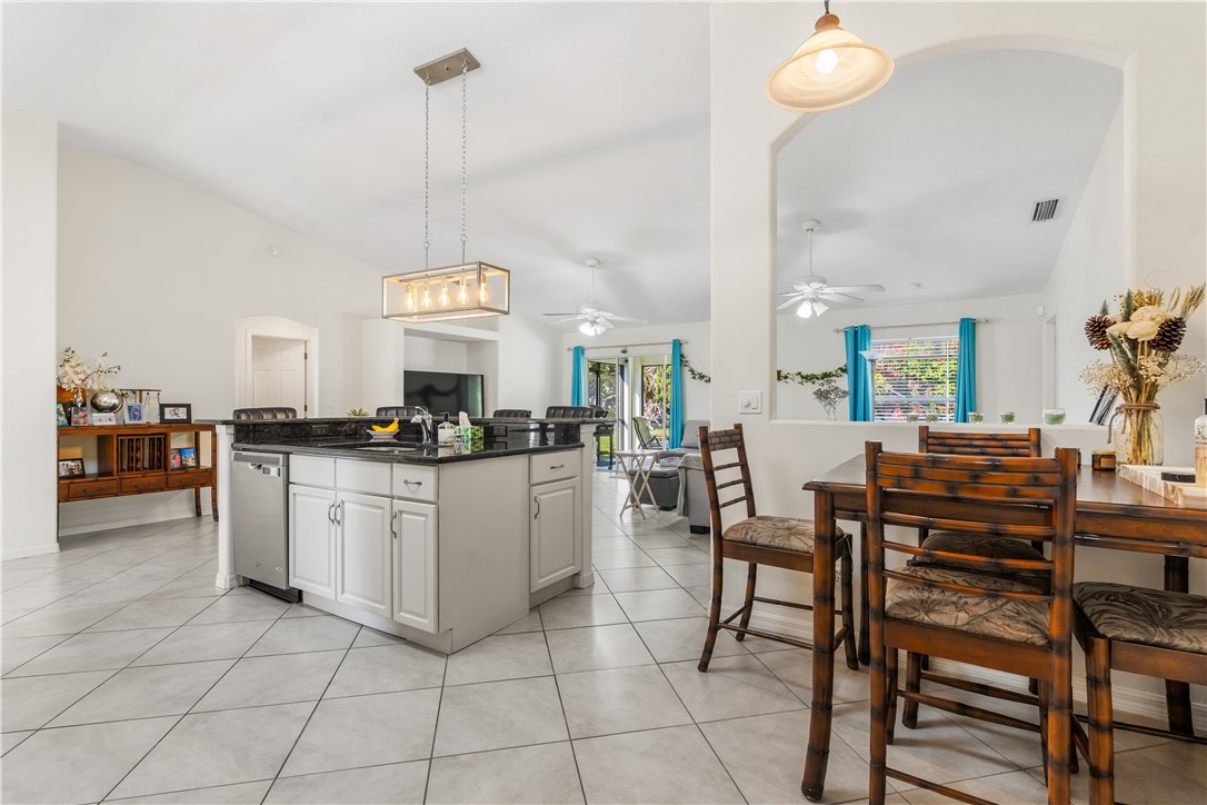 3660 2nd Street Southwest Vero Beach, FL 32968 - Photo 14 of 36 a kitchen with a dining table chairs and white cabinets