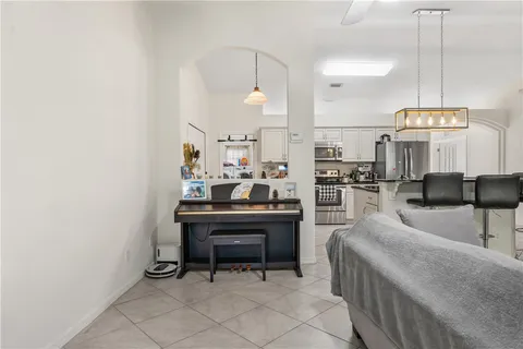 a living room with furniture a fireplace and kitchen view