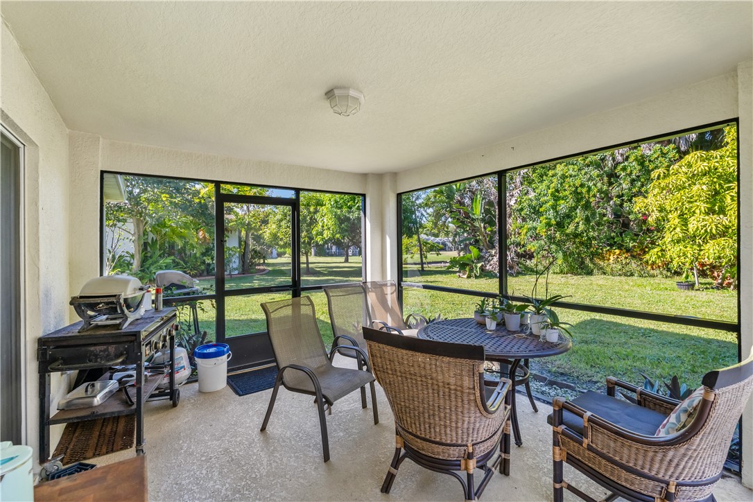 3660 2nd Street Southwest Vero Beach, FL 32968 - Photo 19 of 36 a view of a dining room with furniture and a floor to ceiling window
