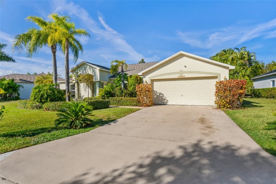 3660 2nd Street Southwest Vero Beach, FL 32968 - Photo 31 of 36 a front view of a house with a yard and garage