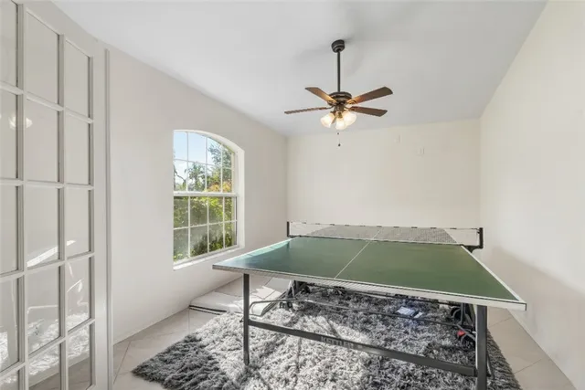 a living room with a window and a rug