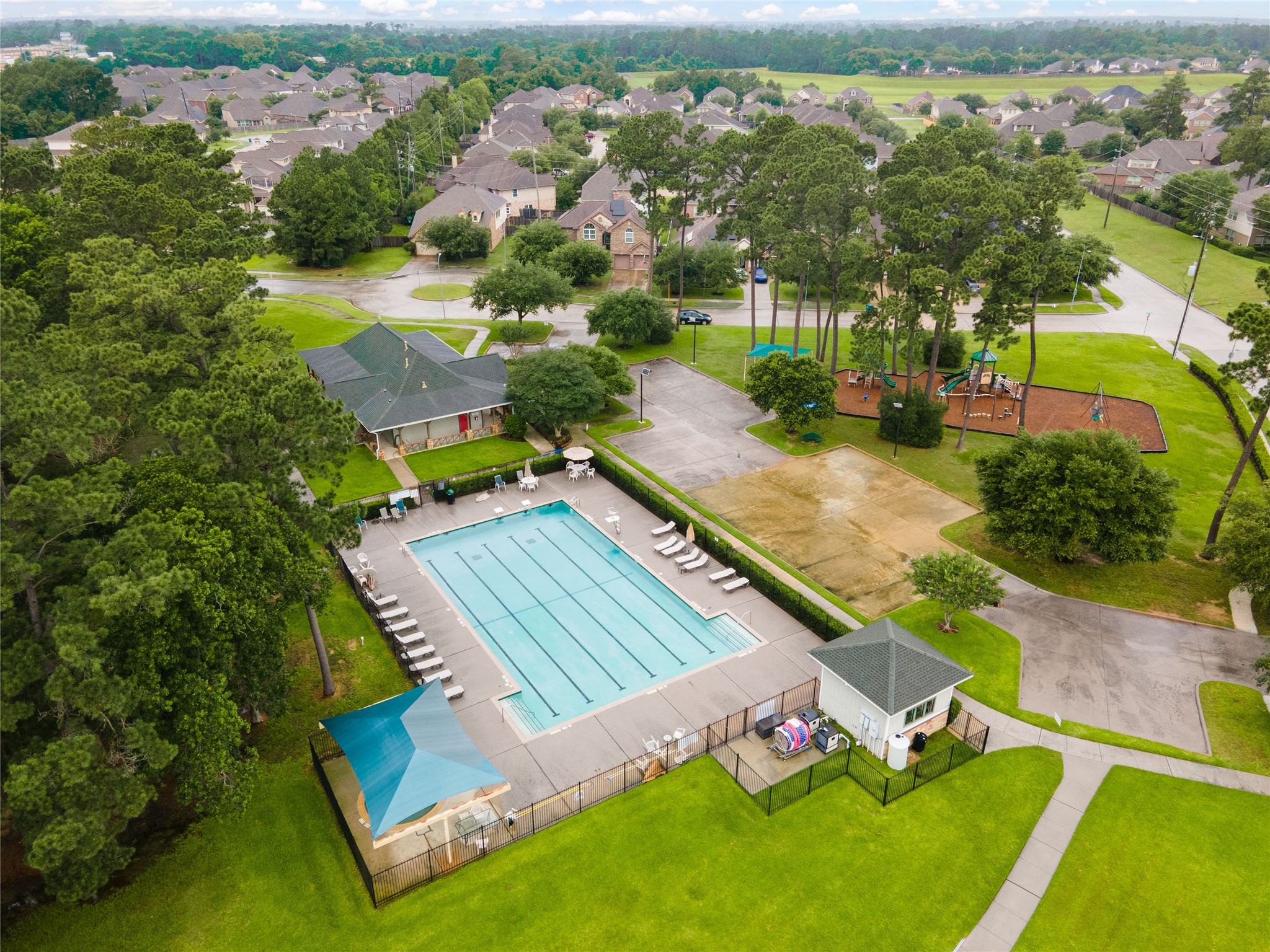 6007 Valhalla Drive Spring, TX 77379 - Photo 36 of 37 Resort-style neighborhood amenities include a community pool surrounded by lush landscaping and gathering areas.