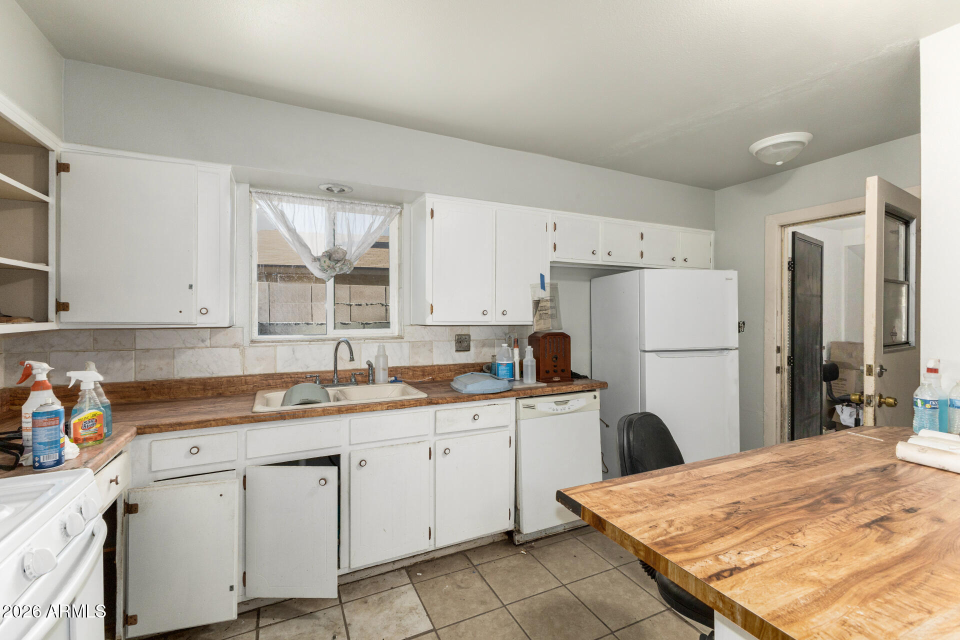 463 South Daley Mesa, AZ 85204 - Photo 8 of 28 a kitchen with a sink a refrigerator and white cabinets