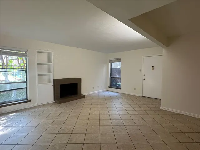 an empty room with fireplace