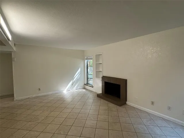 an empty room with fireplace