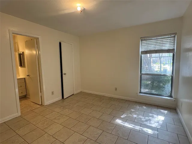 en empty room with windows and fan