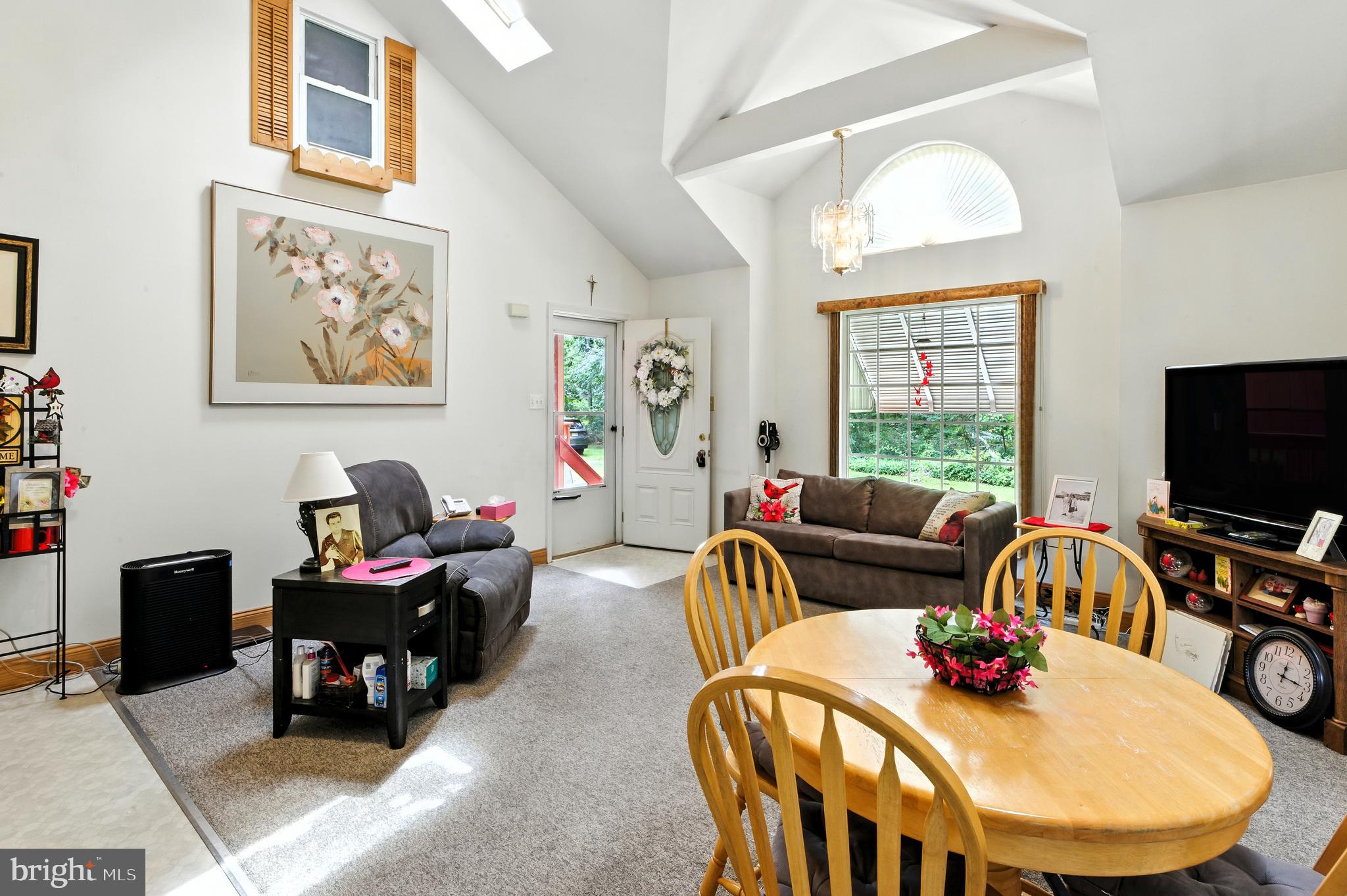112 Hammonton Buena, NJ 08310 - Photo 12 of 34 a living room with furniture a flat screen tv and a large window