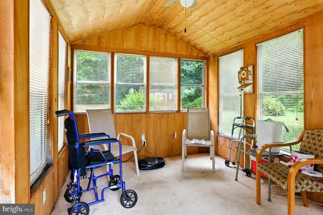 a bedroom with furniture and a large window