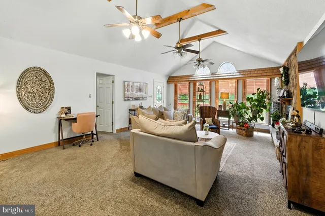 a living room with furniture a window and a chandelier