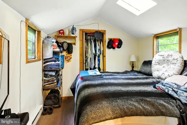 a bedroom with bed and a window