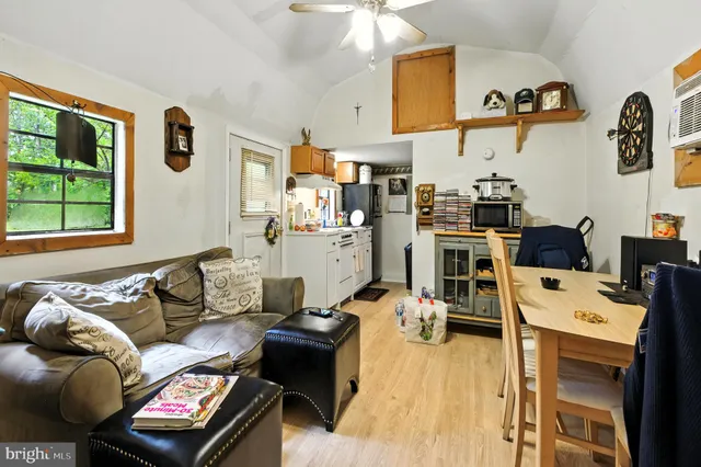 a living room with furniture cabinets and a window