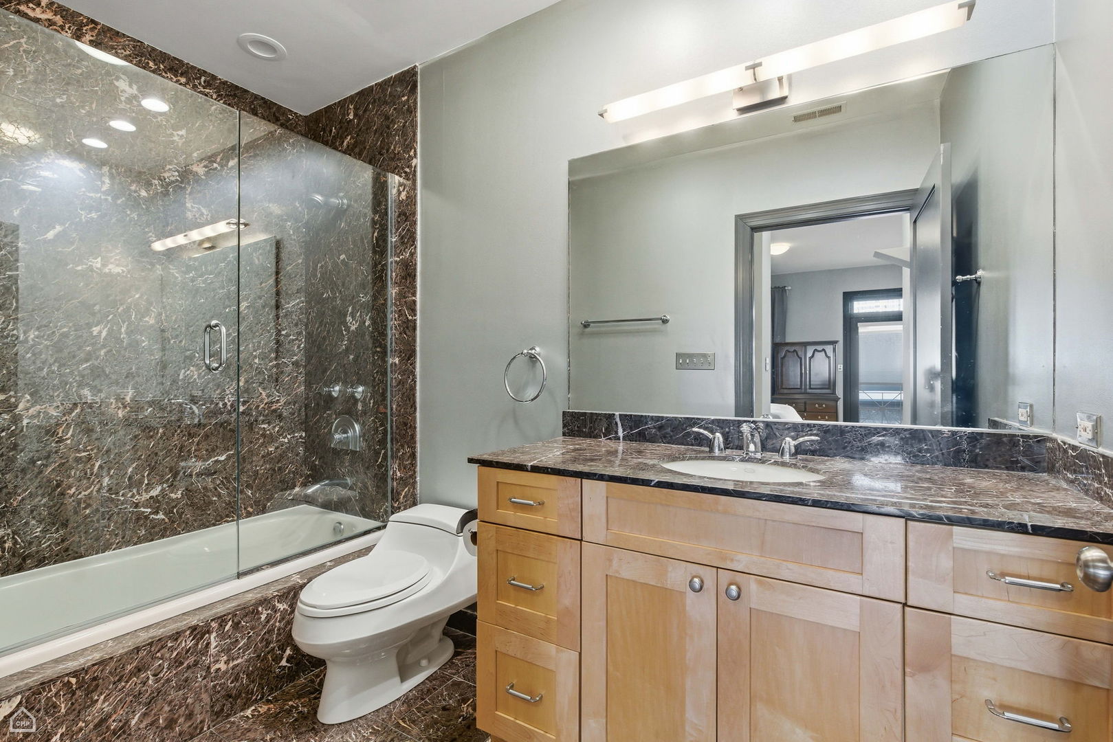 120 West Oak Street, Unit 4D Chicago, IL 60610 - Photo 9 of 18 a bathroom with a granite countertop sink toilet a mirror and shower