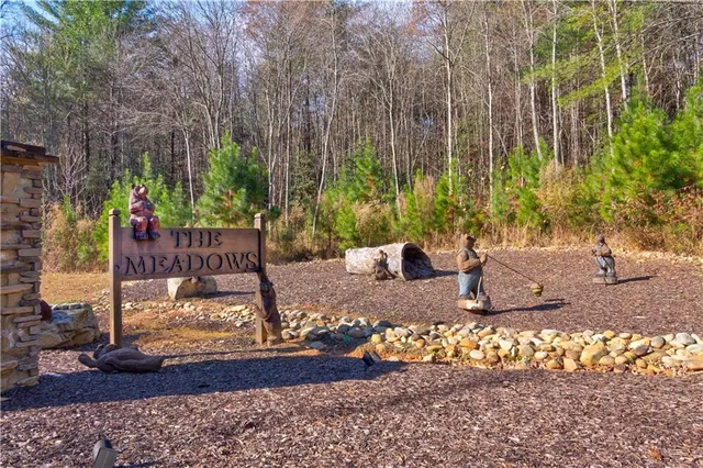 a view of a backyard with plants and sitting area