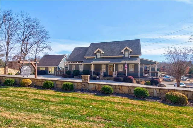 a front view of a house with a yard table and chairs