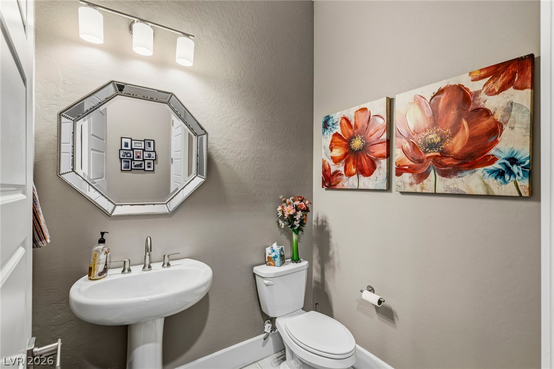 10167 Copper Edge Road Las Vegas, NV 89148 - Photo 22 of 45 A compact powder room with stylish fixtures and decorative artwork creating an inviting atmosphere.