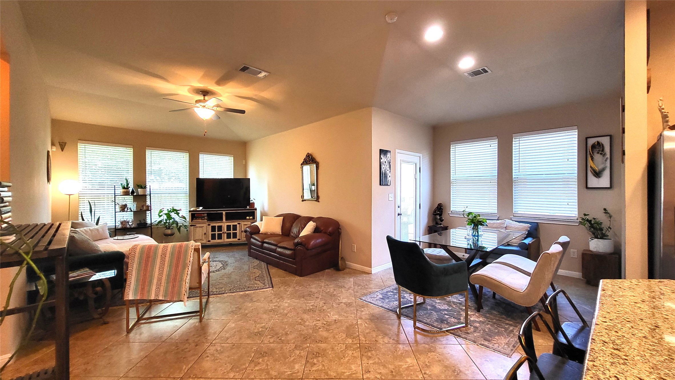 413 Anacua Loop, Unit 8 Manchaca, TX 78652 - Photo 10 of 23 An open living and dining area connects smoothly beneath high ceilings with durable tile flooring.