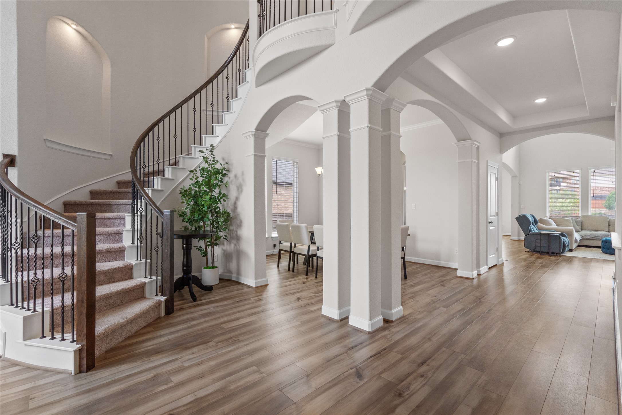 130 Wild Pecan Loop Buda, TX 78610 - Photo 3 of 31 Grand entryway featuring a curved staircase with wrought iron balusters and wood-finish handrails