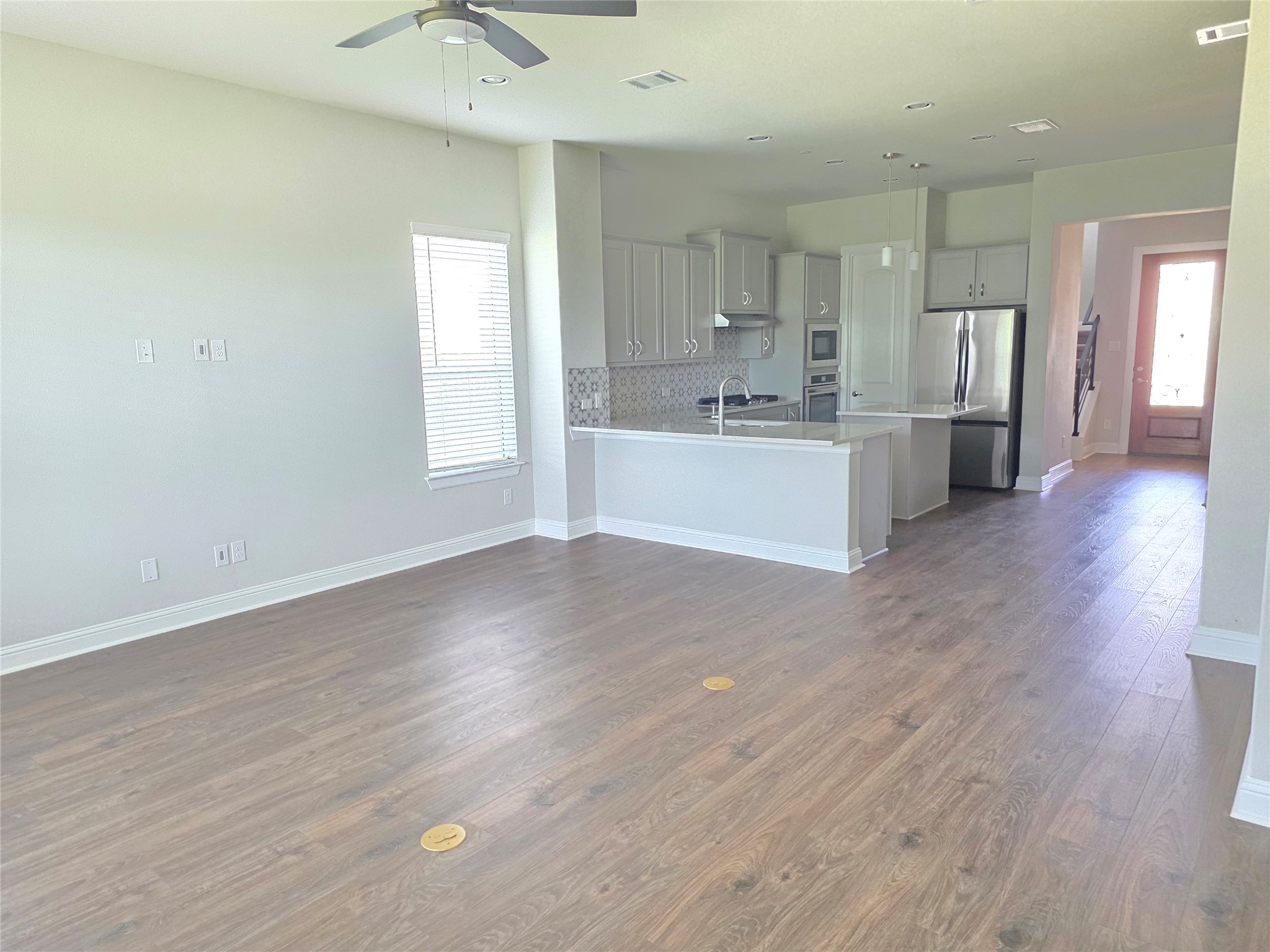 600 C-Bar Ranch Trail, Unit 121 Cedar Park, TX 78613 - Photo 13 of 32 An open-concept living space with sleek flooring flows seamlessly into a modern kitchen.