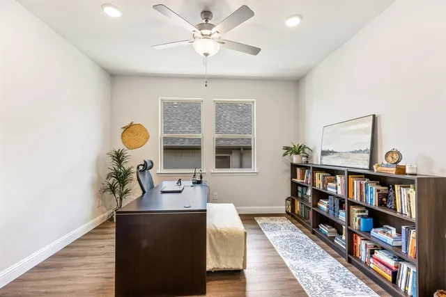 a kitchen with stainless steel appliances granite countertop a stove a sink dishwasher and a dining table with wooden floor