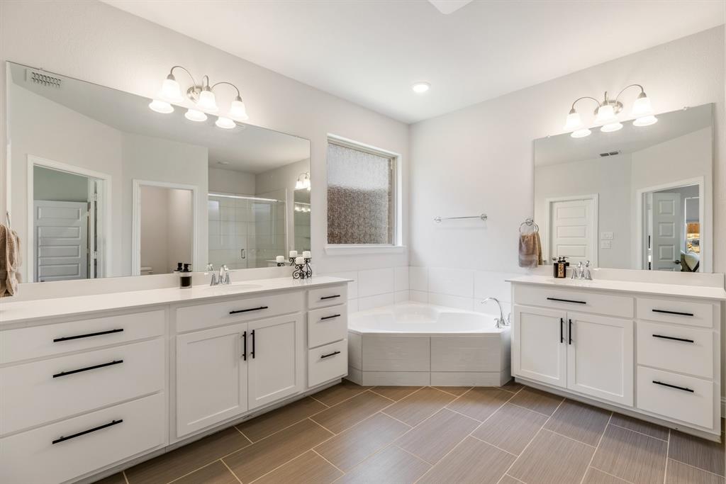 313 Savannah Lane Oak Point, TX 75068 - Photo 10 of 39 Full bath featuring two vanities, a shower stall, and a bath