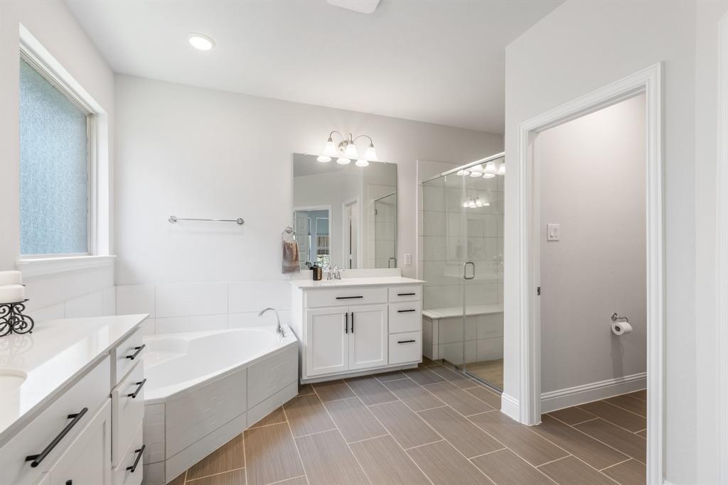 313 Savannah Lane Oak Point, TX 75068 - Photo 11 of 39 Full bathroom featuring a garden tub, a stall shower, and two vanities