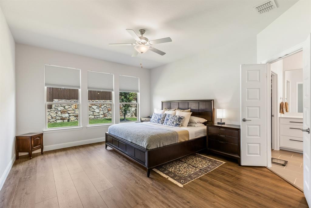 313 Savannah Lane Oak Point, TX 75068 - Photo 12 of 39 Bedroom with dark wood-style flooring and a ceiling fan