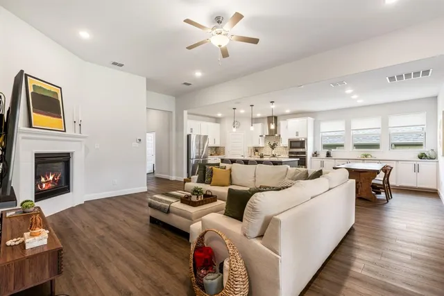a living room with furniture fireplace and a view of kitchen