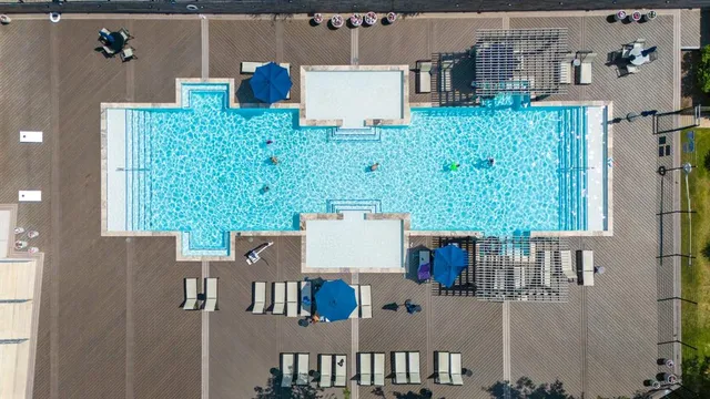 an aerial view of a house with a swimming pool