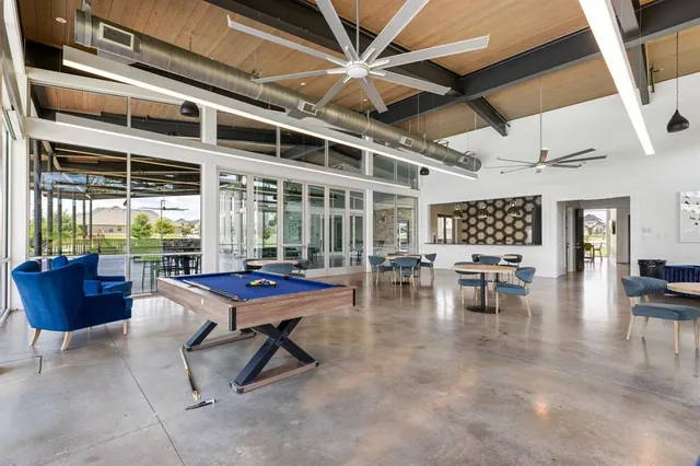 a large kitchen with a large counter top and stainless steel appliances