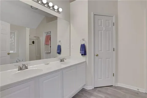 a bathroom with a double vanity sink and a mirror