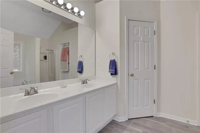 a bathroom with a double vanity sink and a mirror