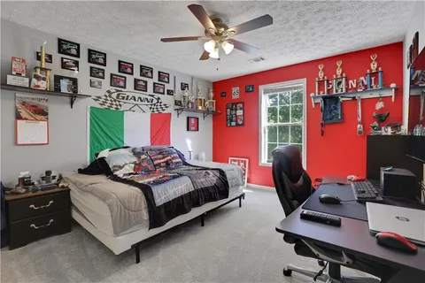 a bedroom with a bed and a desk