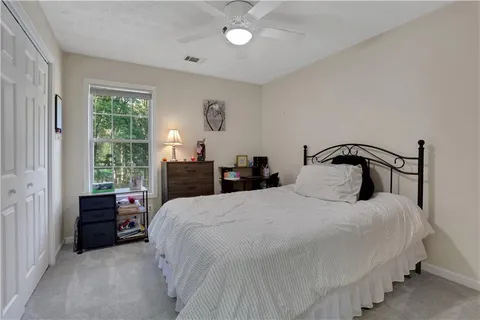 a bedroom with bed and window