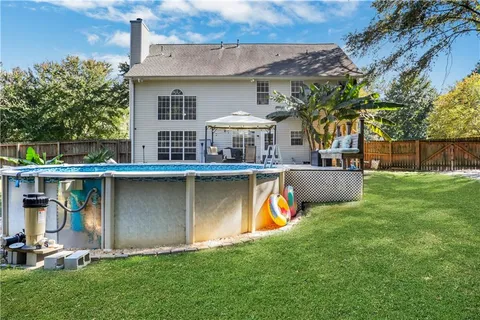 a view of a house with a yard and sitting area