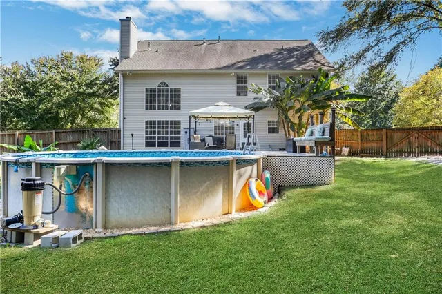 a view of a house with a yard and sitting area