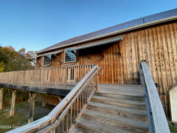 a view of a house with wooden fence