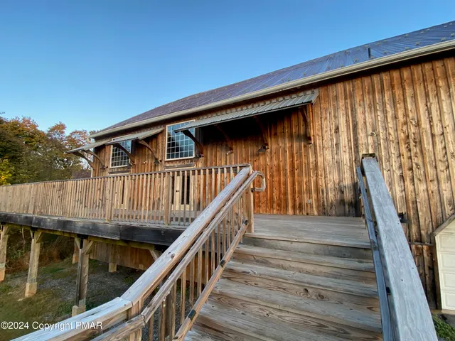 a view of a house with wooden fence