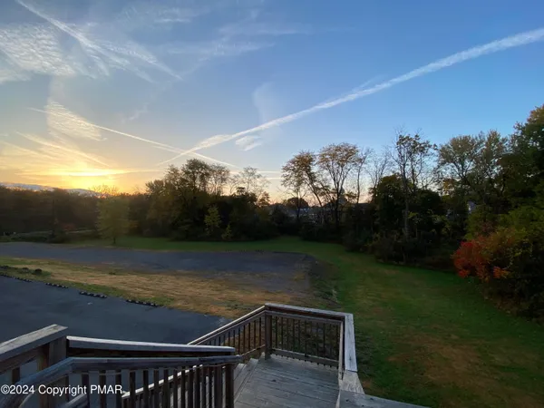 a view of a room with lots of wooden furniture