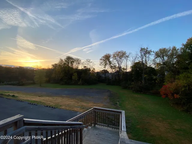 a view of a room with lots of wooden furniture