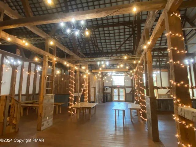 a view of a room with lots of dining space and a chandelier