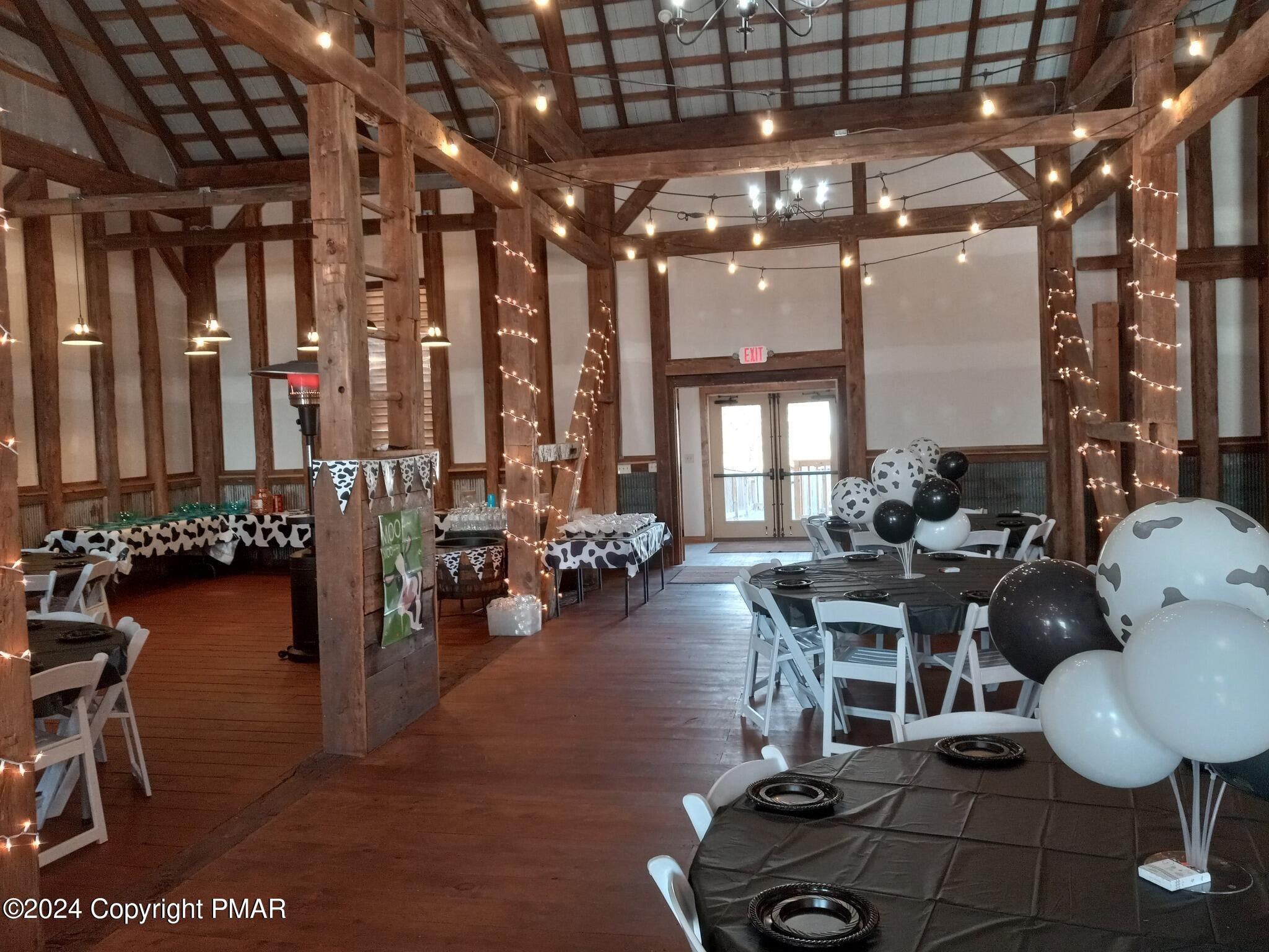 10491 River Road New Columbia, PA 17856 - Photo 37 of 72 a gym room with lots of chairs and a chandelier
