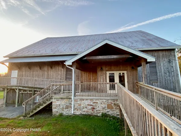 a view of a house with a small yard and wooden fence