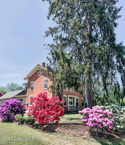 a bathroom with a sink a mirror and shower