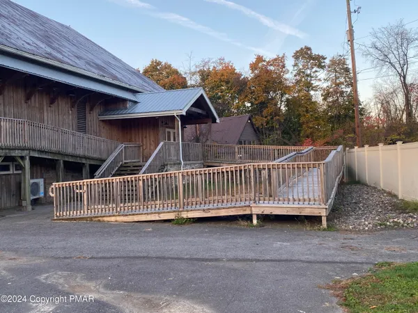 a view of a house with wooden fence