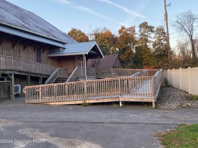 a view of a house with wooden fence