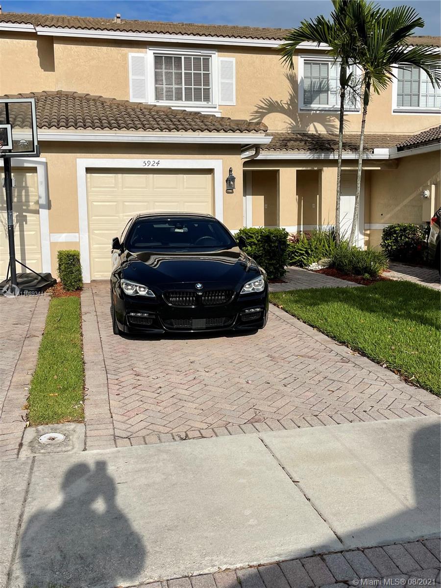 5924 Abbey Road Tamarac, FL 33321 - Photo 1 of 44 a car parked in front of a house