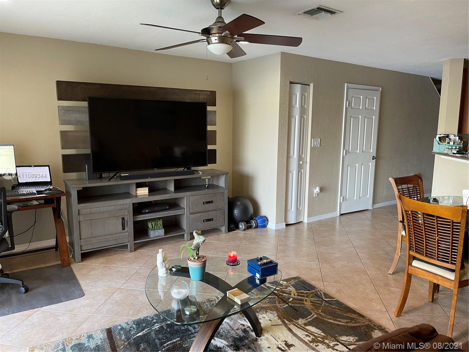 5924 Abbey Road Tamarac, FL 33321 - Photo 11 of 44 a living room with furniture and a flat screen tv
