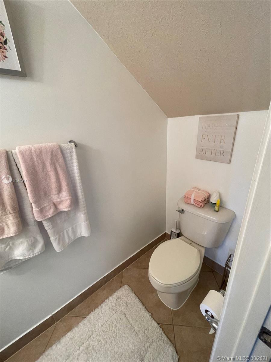 5924 Abbey Road Tamarac, FL 33321 - Photo 15 of 44 a white toilet sitting next to a bathroom sink